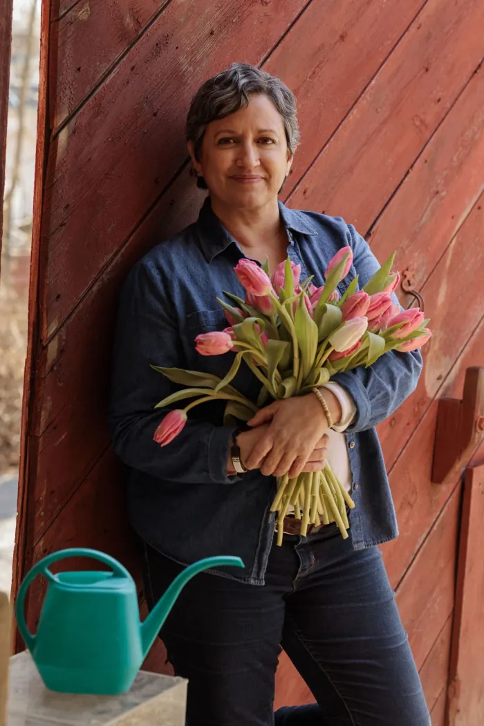 Co-owner Xenia D’Ambrosi holding a bouquet of tulips